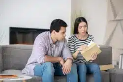 A couple opens a letter.