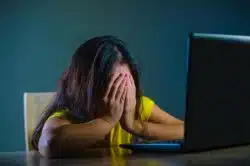 Zoom security issues causing woman to be distressed on laptop