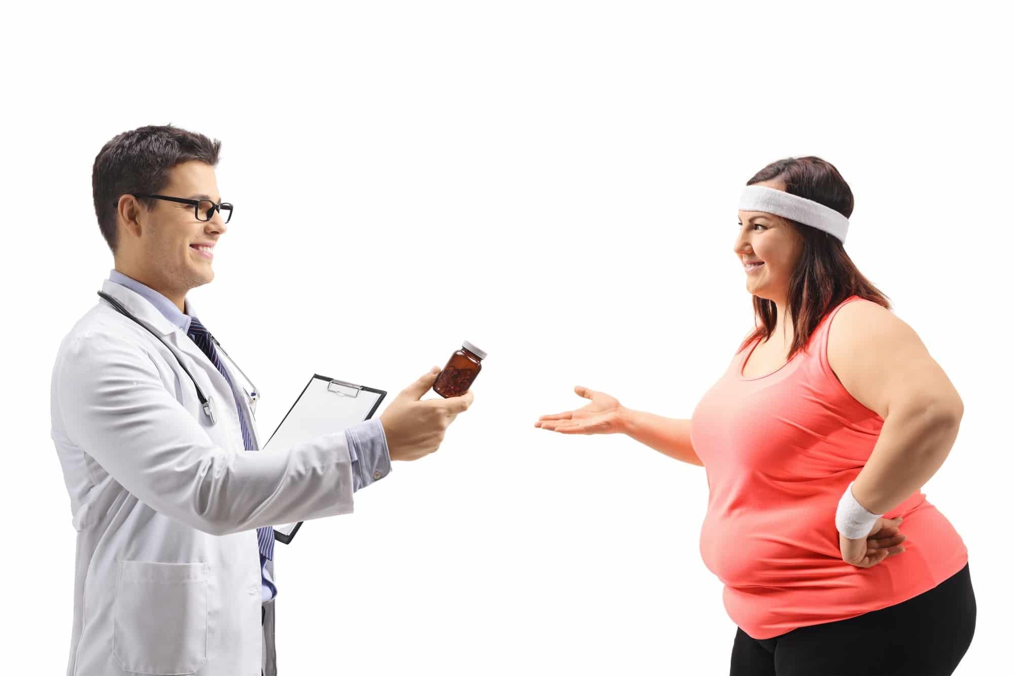 Male doctor hands pill bottle to overweight female patient