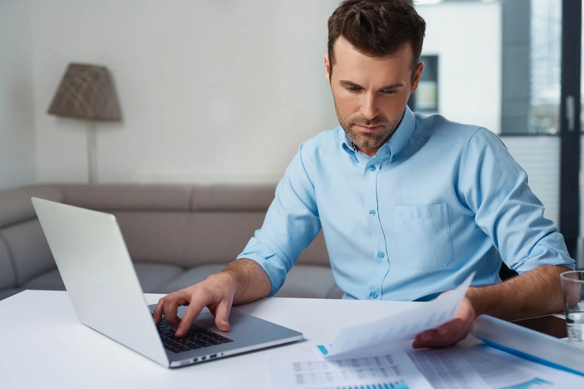 man working on bank statments