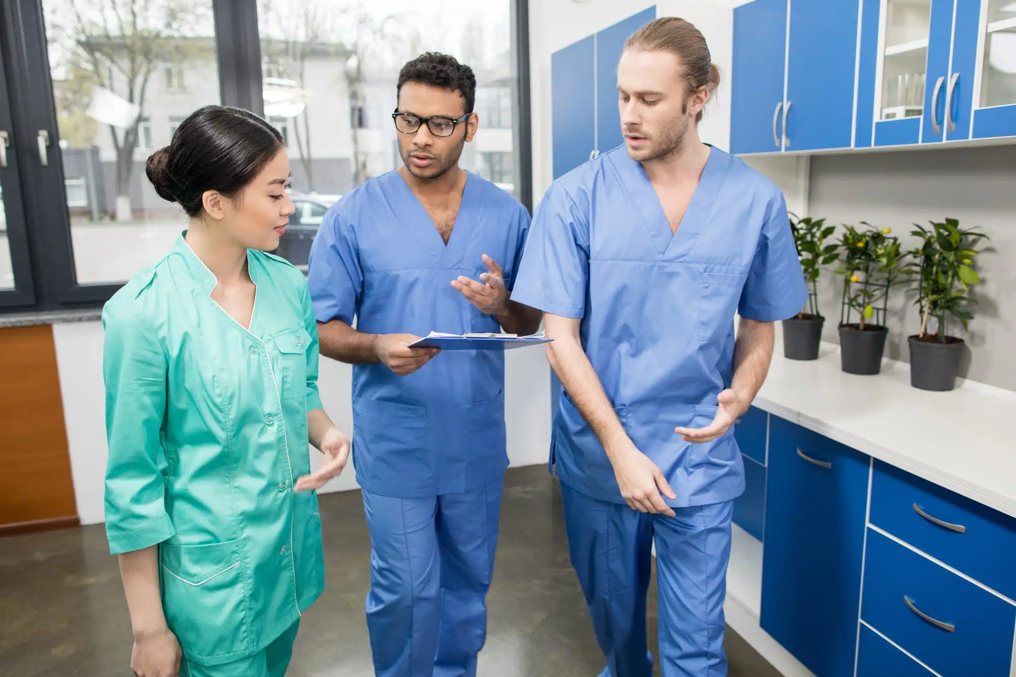 Three hospital employees at work