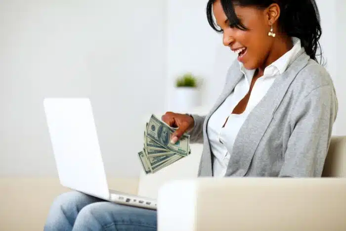 woman on computer filing for class action rebates