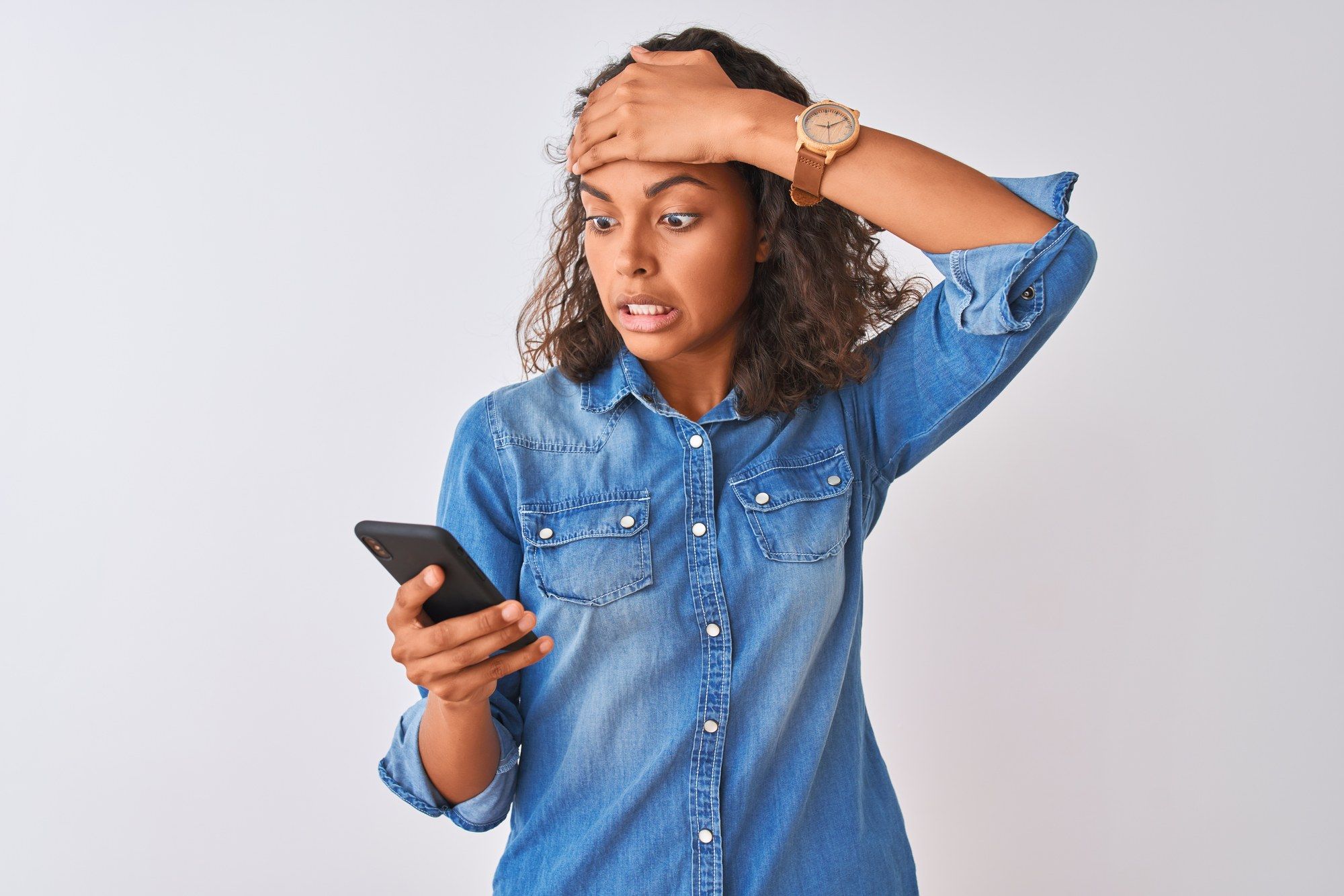 A woman is upset by news on her phone.
