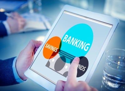 Man holding tablet showing online banking screen