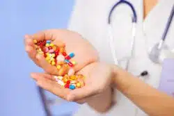 Close up of doctor's hands holding pills