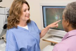 Female eye doctor shows female patient a film of her retina
