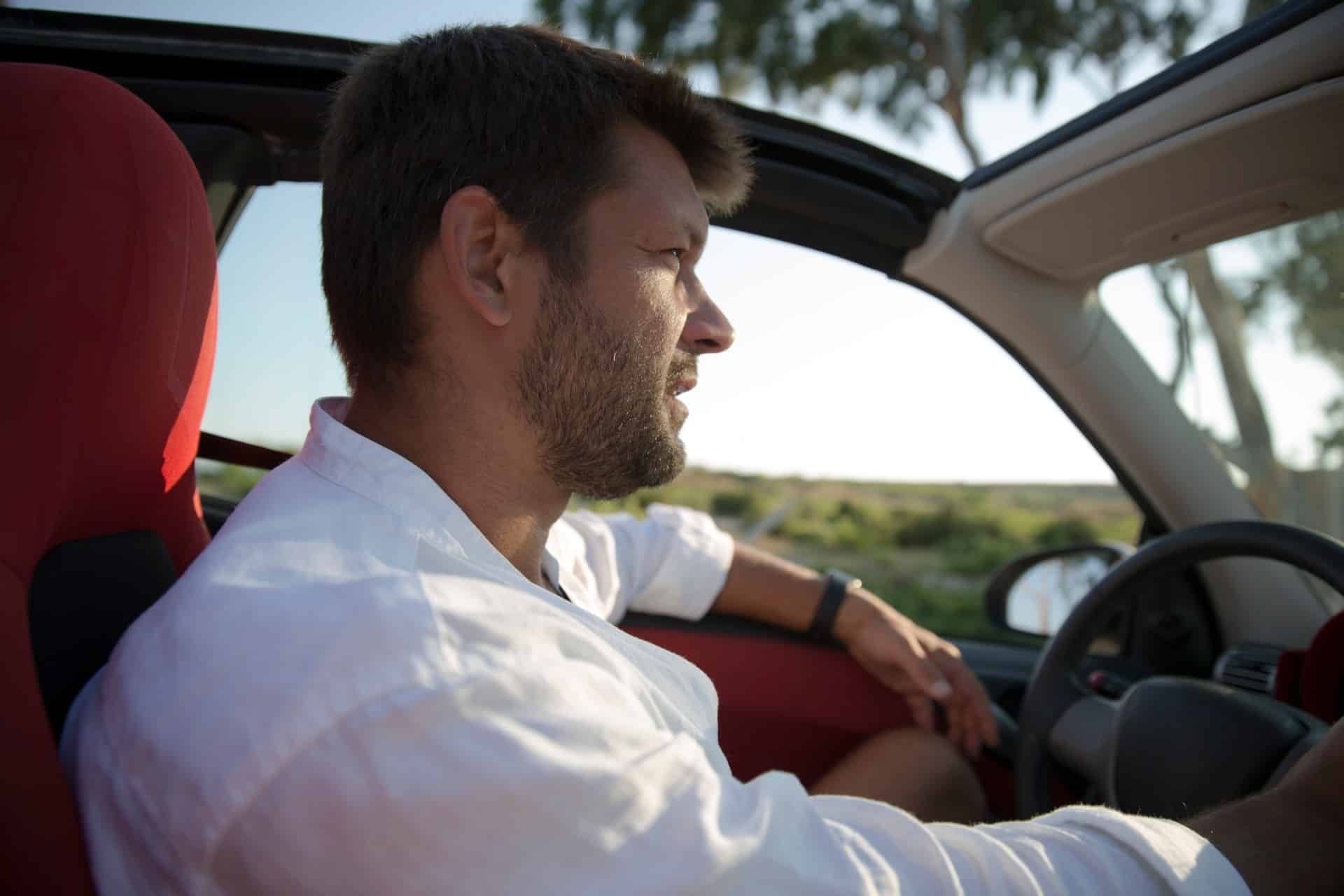 Man driving a car with a sunroof