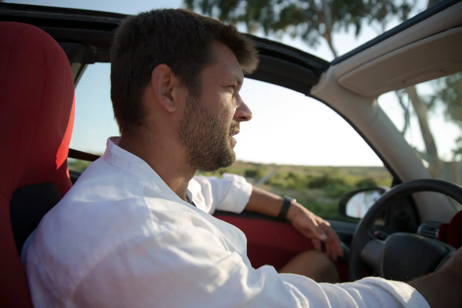 Man driving a car with a sunroof