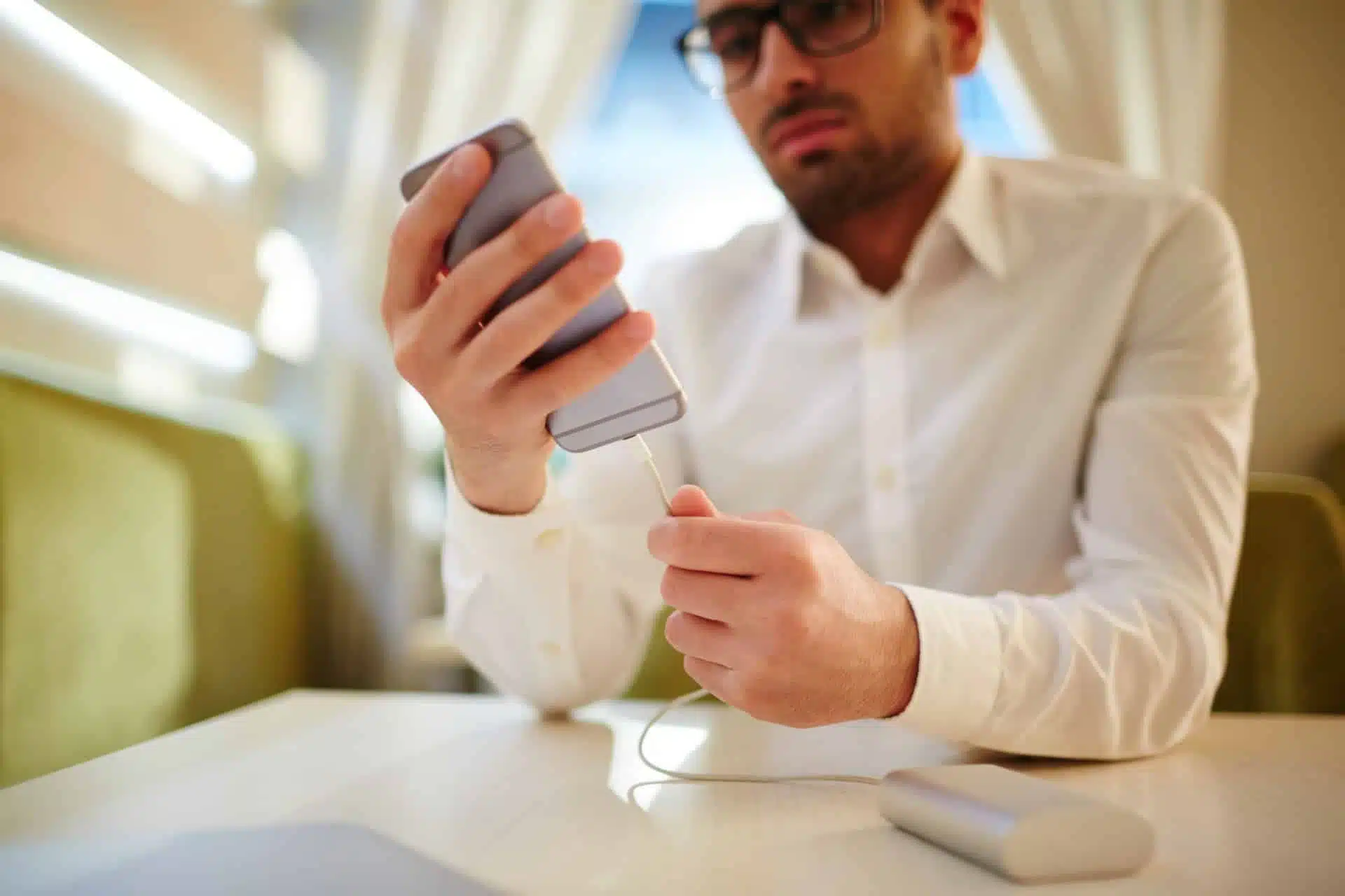 Man plugs iphone into portable power bank