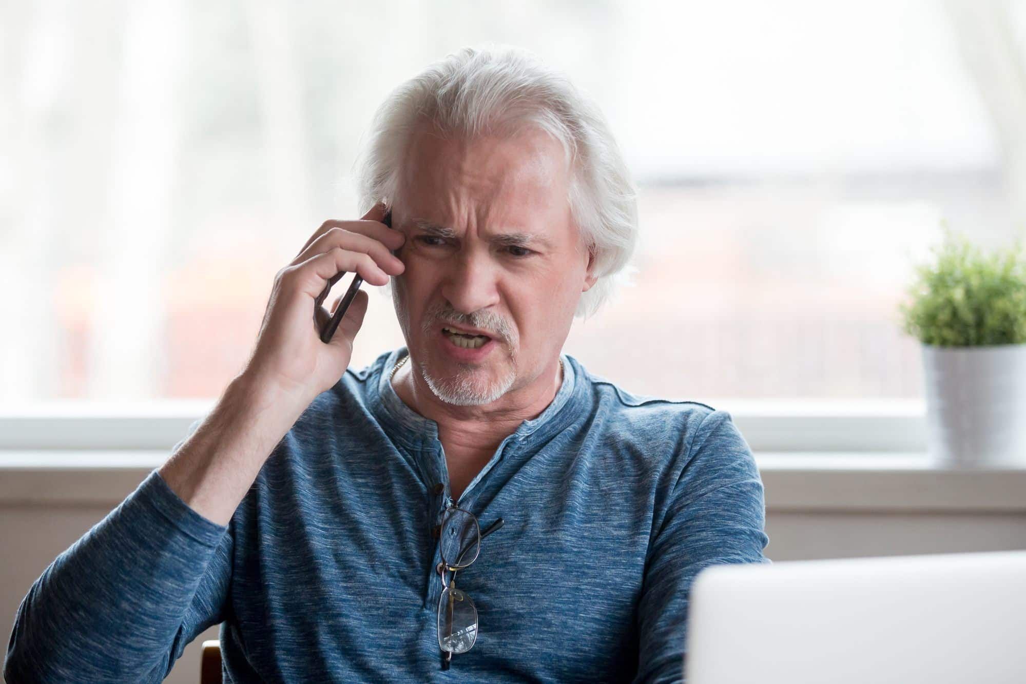 man receiving unwanted spam call