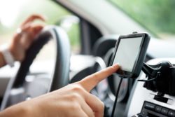 person using Magellan RoadMate car Navigator