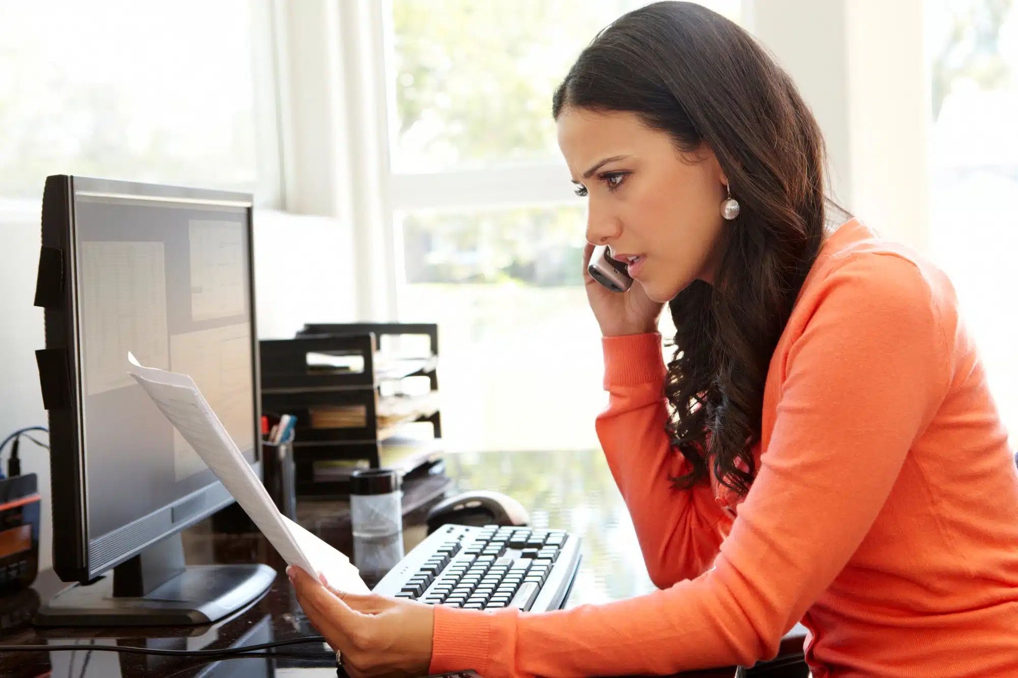 A woman makes a payment over the phone.