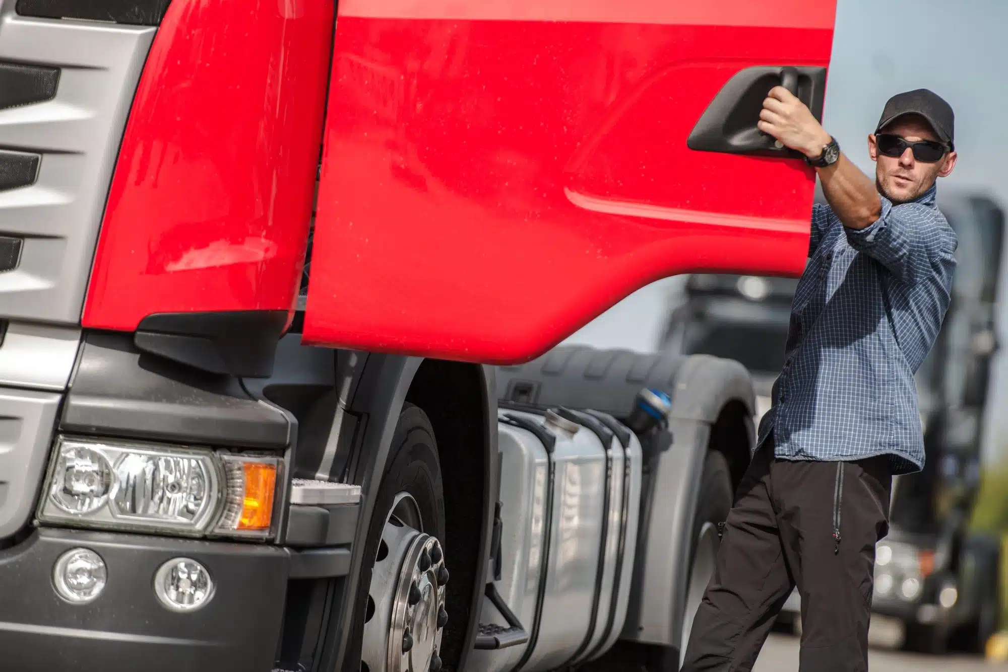 truck driver getting into truck cab