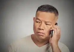 unhappy man on phone because of AmeriSave mortgage