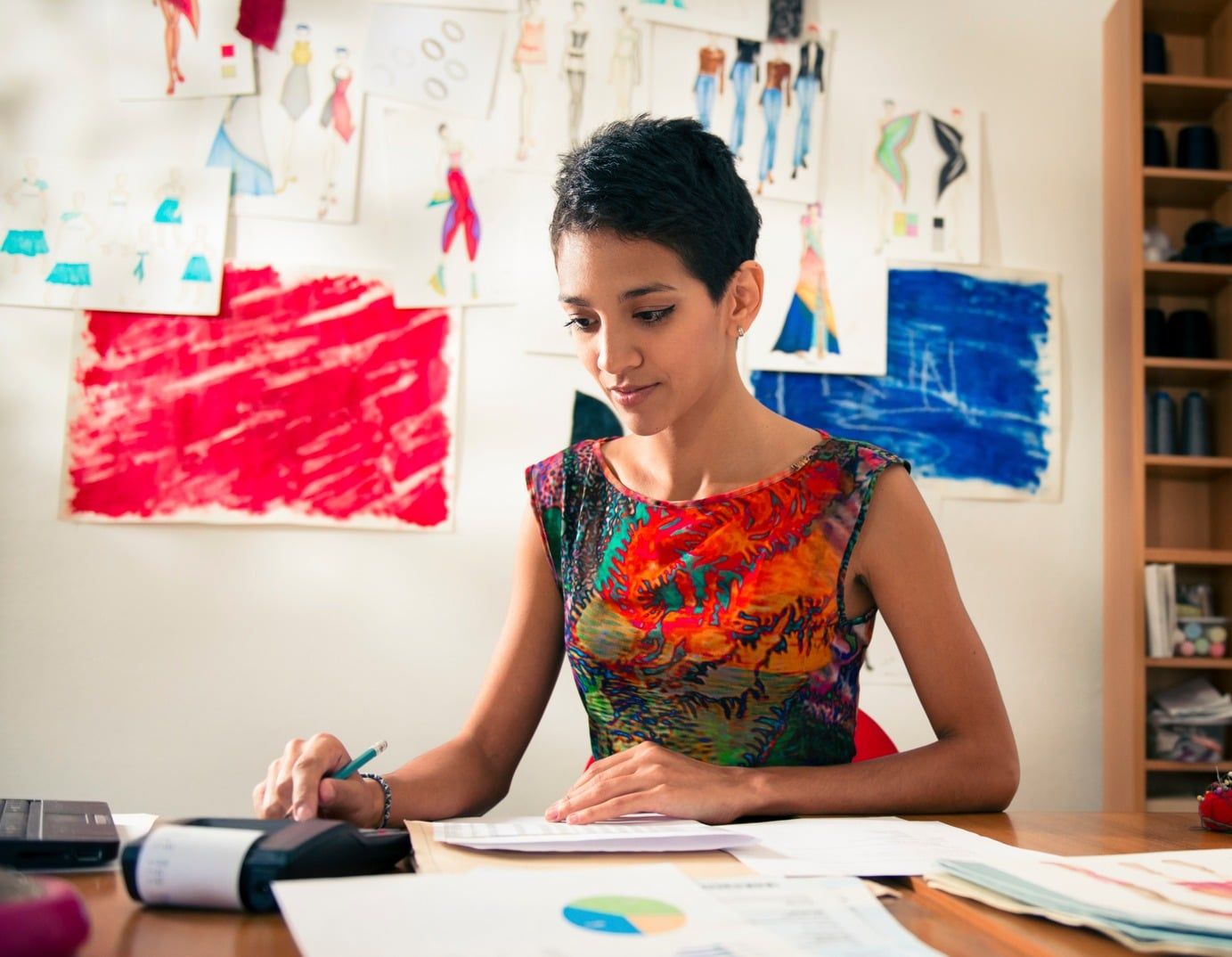 A woman does paperwork at home.