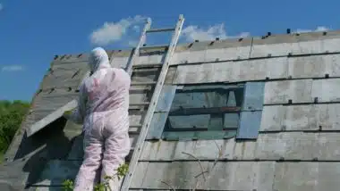 Asbestos removal worker in protective suit