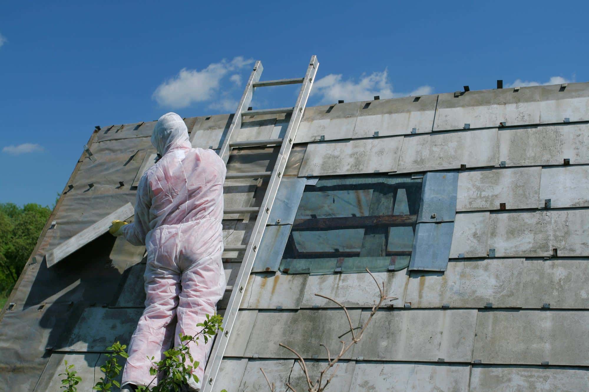 Asbestos removal worker in protective suit