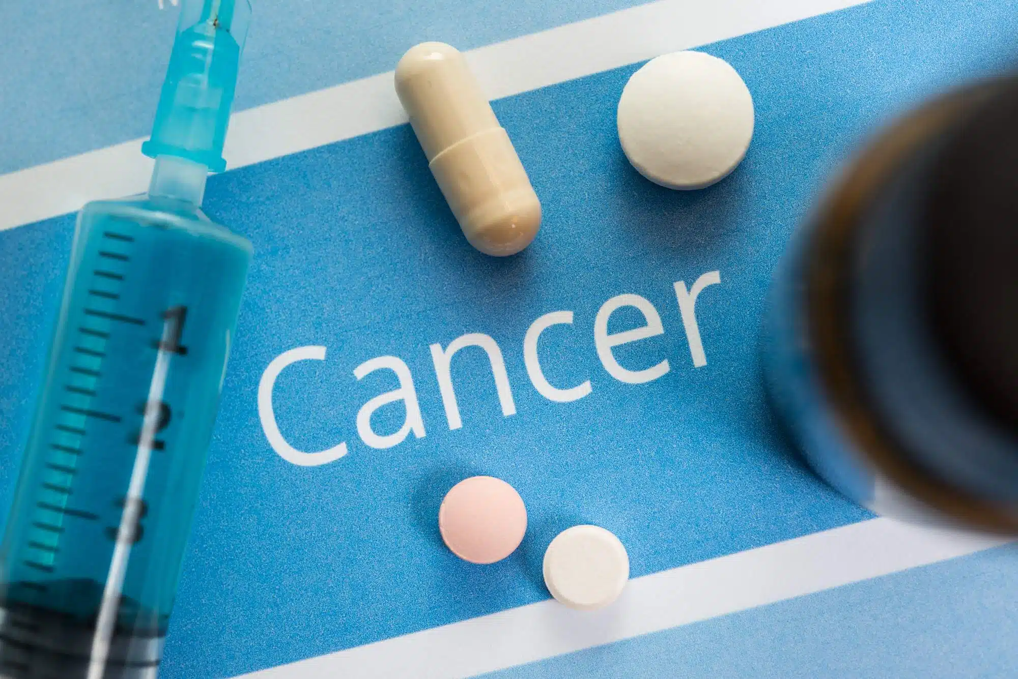 Cancer sign with pills and syringe