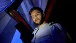 Man looks at cell phone texts