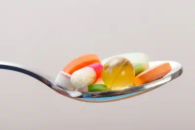 Vitamin supplements in a spoon