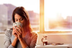 Woman drinking coffee with Chobani creamer