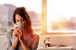 Woman drinking coffee with Chobani creamer