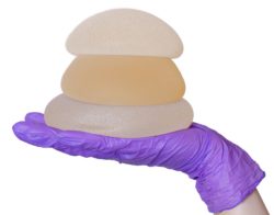 hand holding breast implants