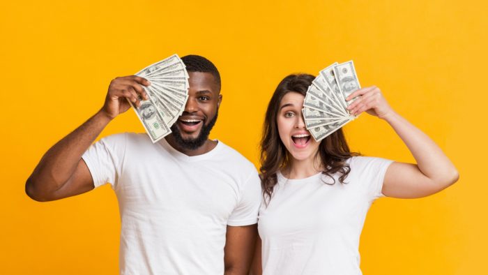 couple holding class action rebates money in their hands