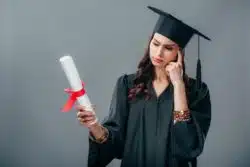DeVry University graduate holding diploma