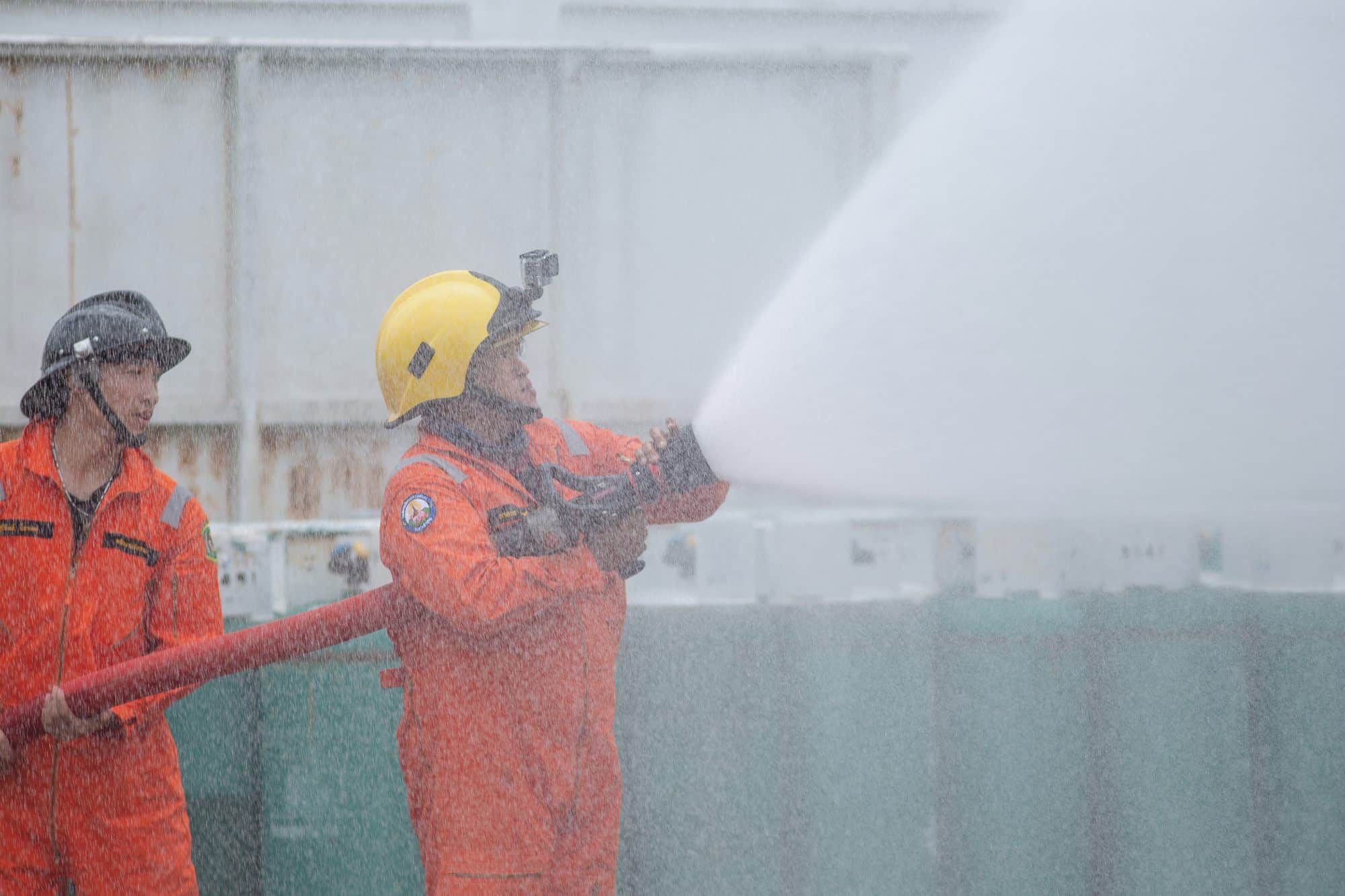 gas plant workers putting out fire