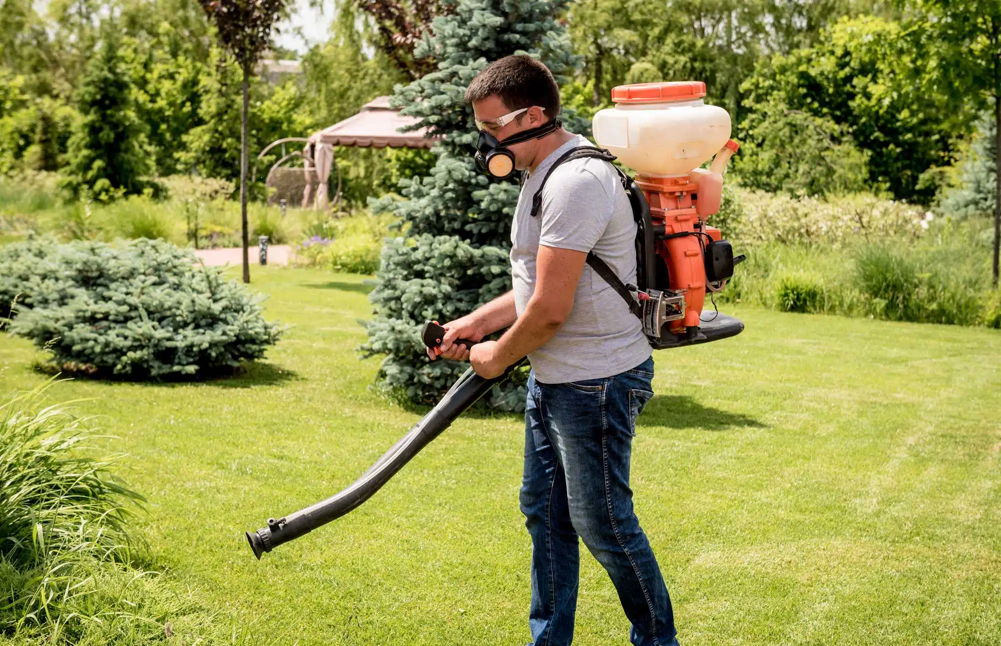 groundskeeper spraying plants