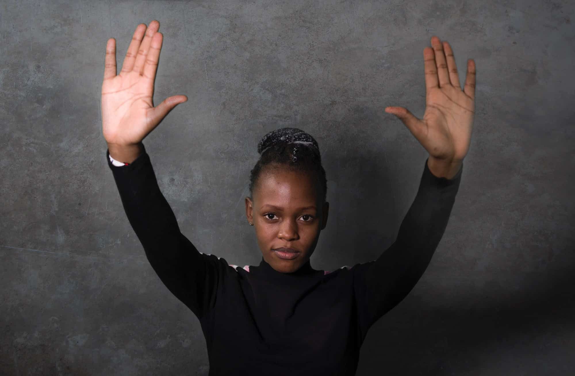 Woman with hands up saying stop racism Assemblers