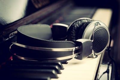 Headphones lying on piano keyboard