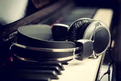 Headphones lying on piano keyboard