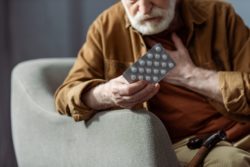 older man with medication having chest pains