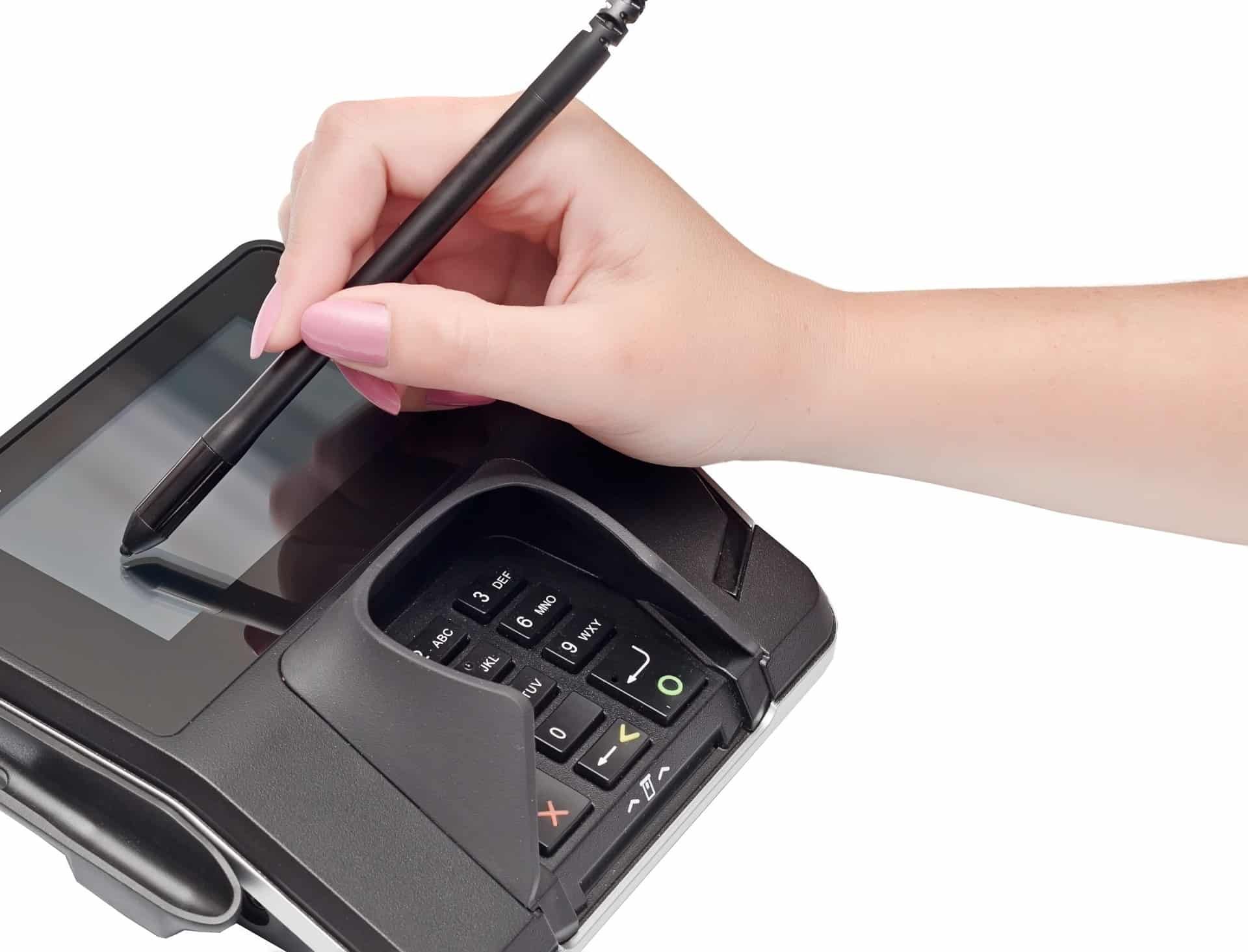 Person signs name on credit-card reader for point-of-sale system