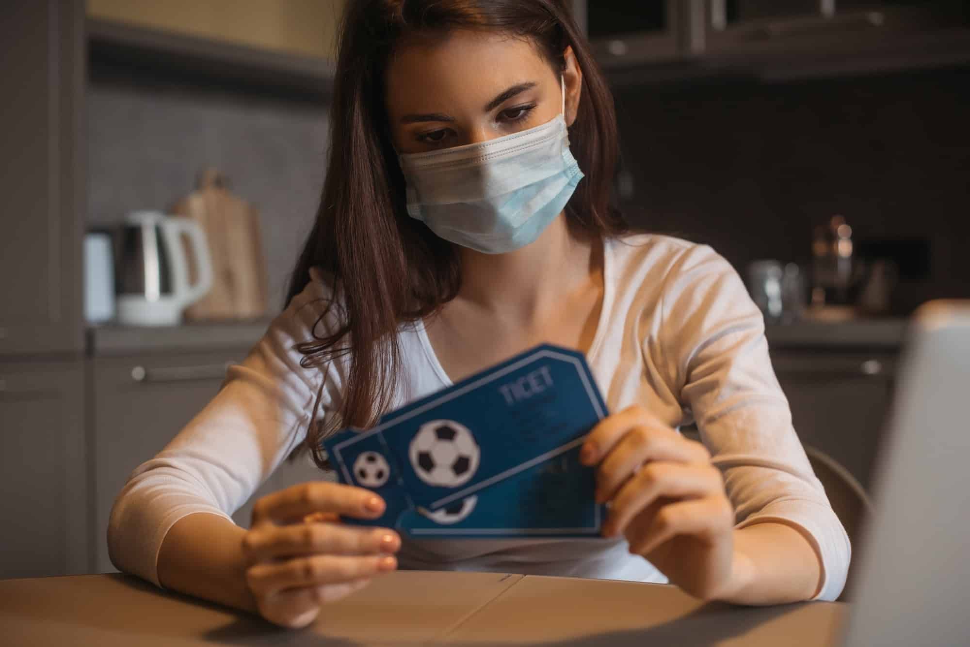 sad woman holding StubHub tickets during coronavirus