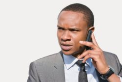 Unhappy man listening to voicemail