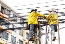 people fixing power lines after storm