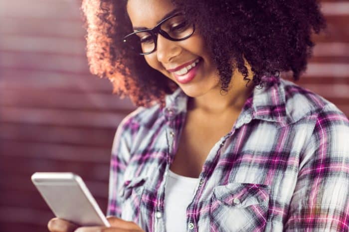 woman receiving a text message from NastyGal