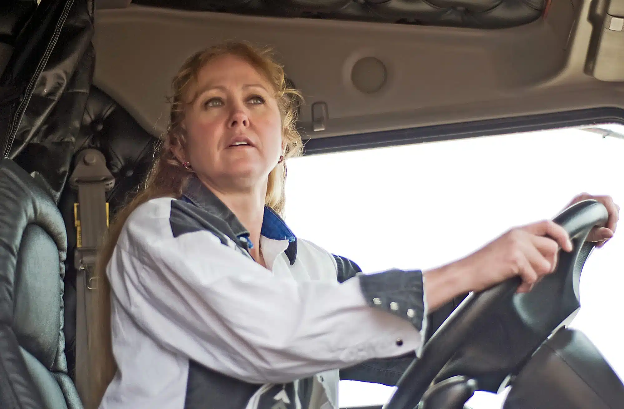 Female semi truck driver drives a truck