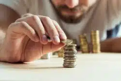Man stacks coins