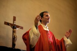Priest preaches at altar