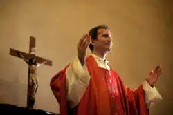 Priest preaches at altar 