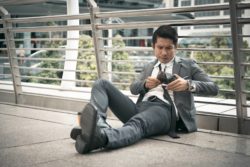 Upset businessman looks in empty wallet