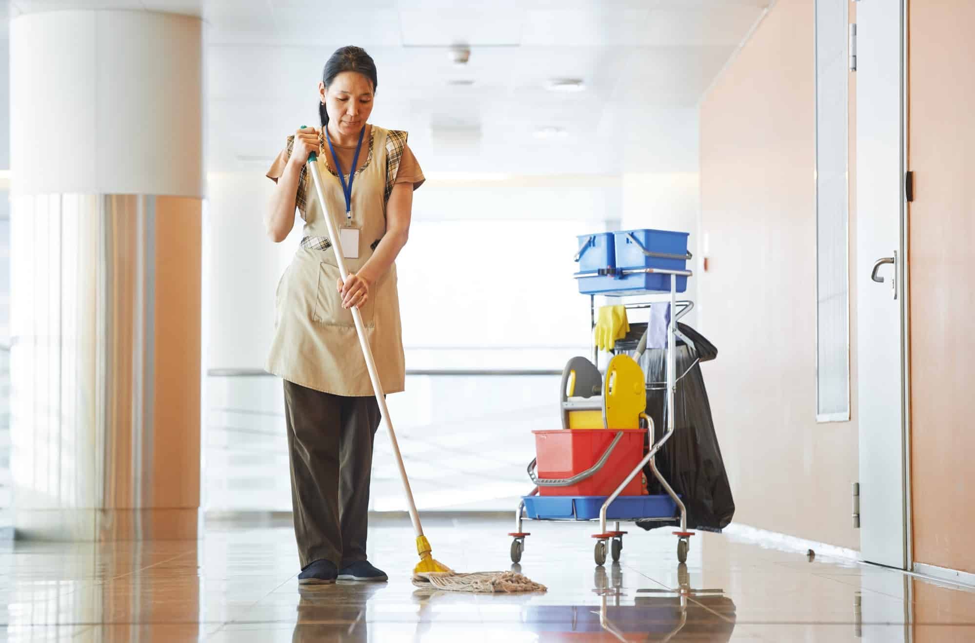 Woman mops hospital floor
