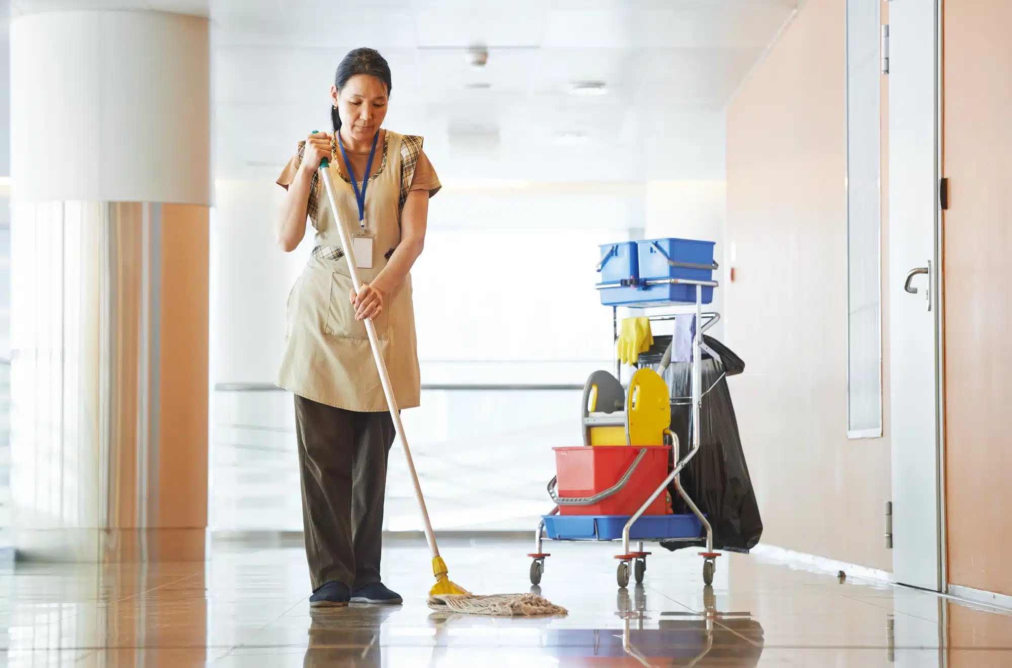 Woman mops hospital floor