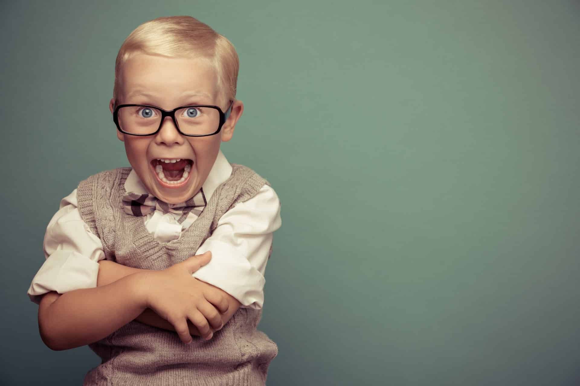 A smiling young boy sits for a portrait - lifetouch photos