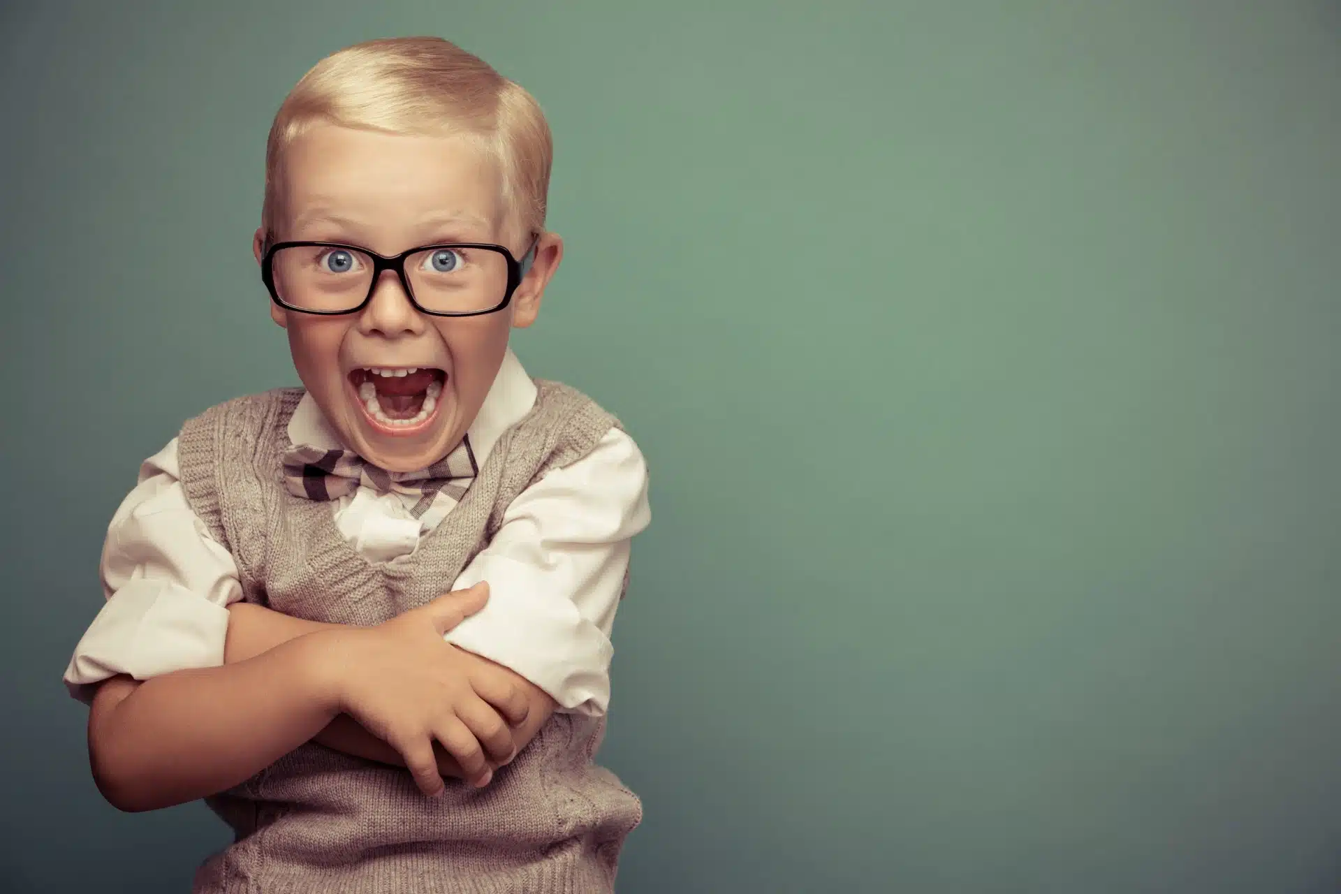 A smiling young boy sits for a portrait - lifetouch photos