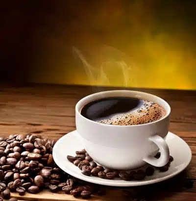 Cup of coffee on saucer surrounded by coffee beans - Maxwell House